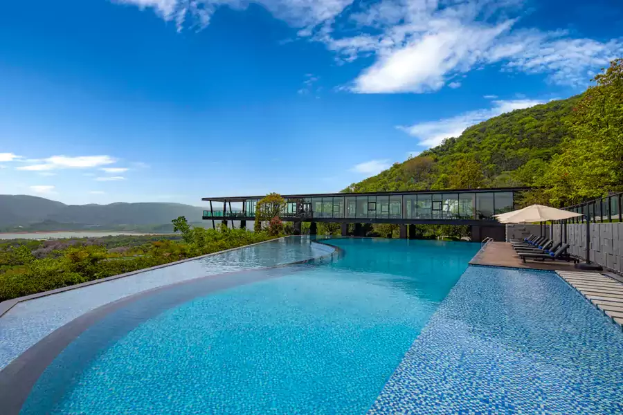 在半山腰的无边泳池边坐着 在半山腰的无边泳池边坐着